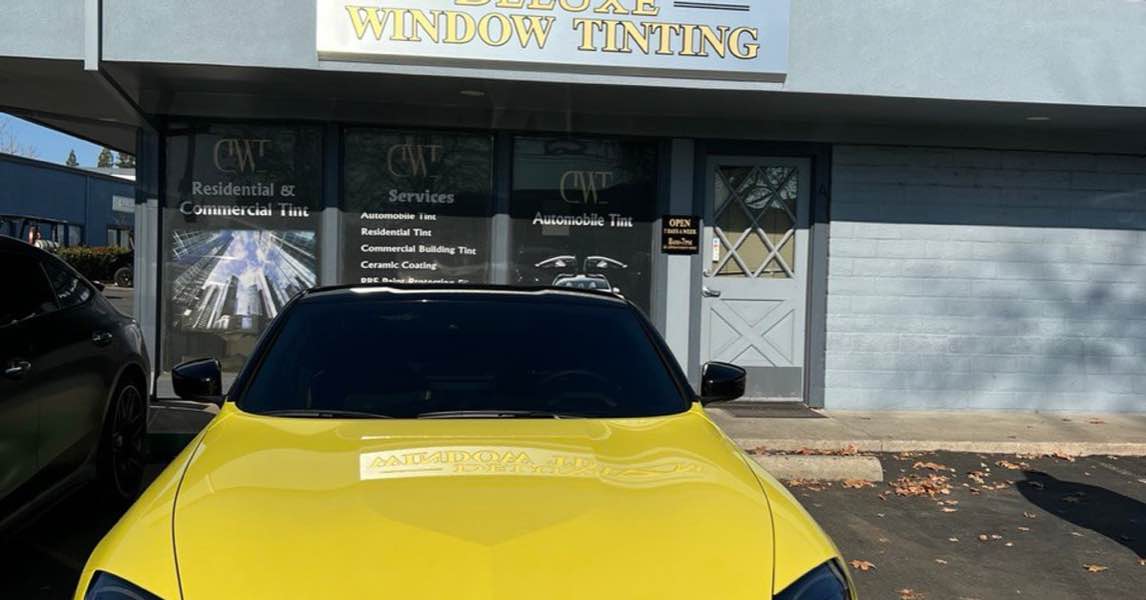 Yellow Nissan Z with professional window tinting parked in front of Deluxe Window Tinting in Gold River.